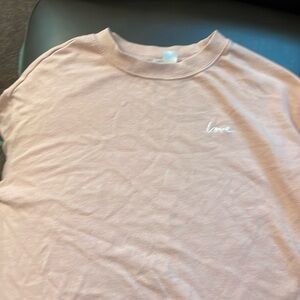 Pink long sleeve top with “love” embroidered on chest.